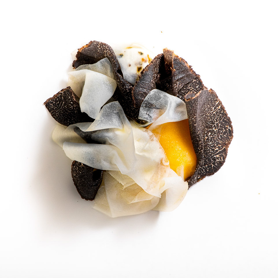 Sliced black truffle over potato